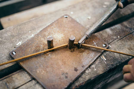 construction worker using industrial tools for bending clamp on construction siteの写真素材
