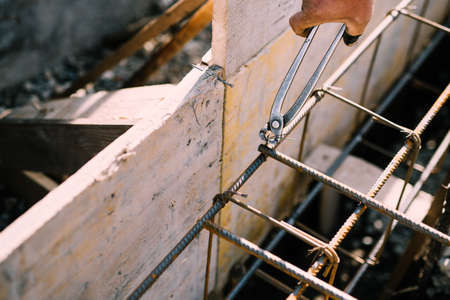 Foundation site of new building, details and reinforcements with steel bars and wire rod, preparing...