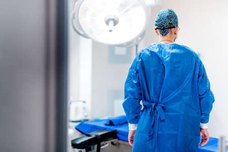 Portrait of surgeon in operating room of hospital. Getting ready for surgery