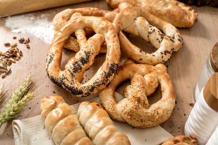 Homemade fresh whole wheat snack pretzels with sesame and salt at local bakeryの写真素材