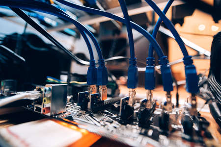 Close up details of mining rig, graphics cards cables and motherboard. Modern technology used for mining bitcoin, ethereum and other alt coinsの写真素材