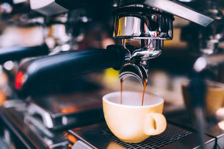 Close up details of brewing machinery pouring and preparing espresso. Cafe shop detailsの写真素材