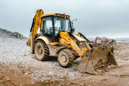 Industrial backhoe excavator and bulldozer in construction site