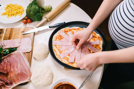 Details of pizza making in new kitchen at homeの写真素材