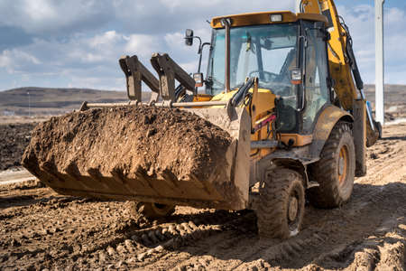 Close up details of industrial backhoe loader, details of machinery on construction siteの写真素材