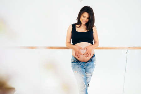 beautiful portrait of pregnancy and maternity concept. Close-up, copy space in new home, in living room. の写真素材