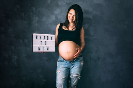 Pregnancy concept - ready to mom concept with beautiful pregnant woman posing and smilingの写真素材
