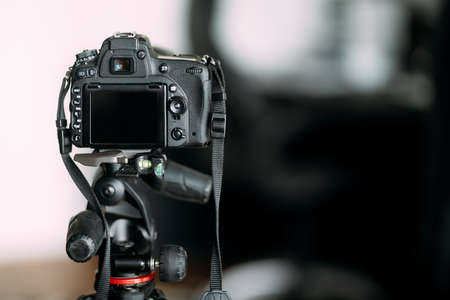 Professional camera standing on tripod, photographing and working with camera stand