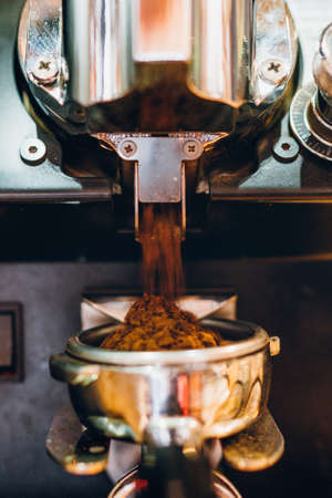 Details of machine pouring and grinding fresh, coffee in local bistro, restaurant or pubの写真素材