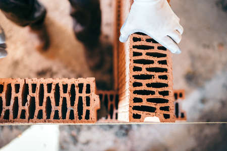 Construction site details - Close up of industrial worker building interior brick wallsの写真素材