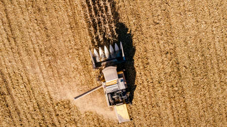 Harvesting Corn aerial details. Farmer using combine and machineryの写真素材
