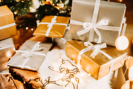 Details of presents under the Christmas tree, handmade decorations and lights