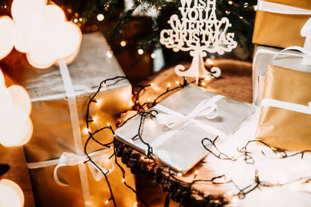 Details of elegant presents and gift boxes under the Christmas Tree