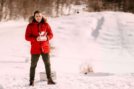 Aerial photography and drone footage details with man operating drone, flying droneの写真素材