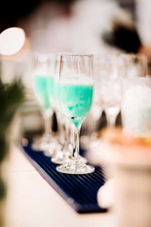 close-up of blue curacao cocktail drink, selective focus and details. alcoholic drink refreshment at...
