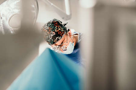 Details of surgeon doctor performing invasive surgery in hospital room