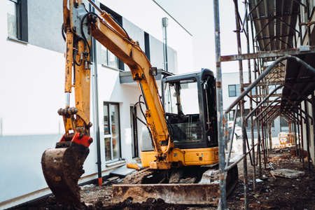 Heavy duty excavator using small scoop for digging on construction site