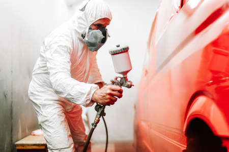close up details of industrial worker, mechanic engineer using a paint gun and painting a carの写真素材