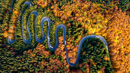 Aerial view of mountain curved road with truck heavy traffic. Beautiful asphalt serpentine roads...