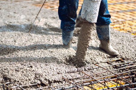 pouring cement or concrete into slabs layers of new house. Construction site detailsの写真素材