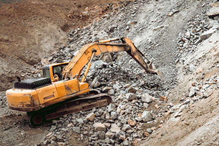 Hydraulic crusher and track type excavator backhoe machinery working on site demolition and...