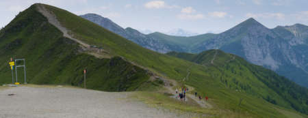 hiking path on mountain ridges during a windy day on goldeckの写真素材