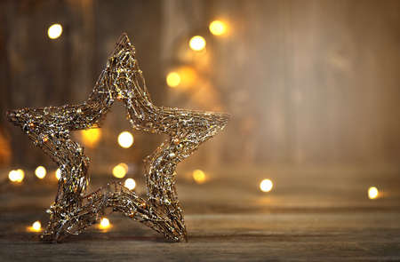 Beautiful christmas star close up and christmas decoration with lghts on a wooden background