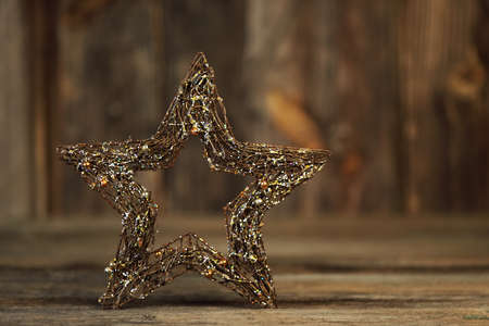 Beautiful christmas star close up and christmas decoration with lghts on a wooden backgroundの写真素材