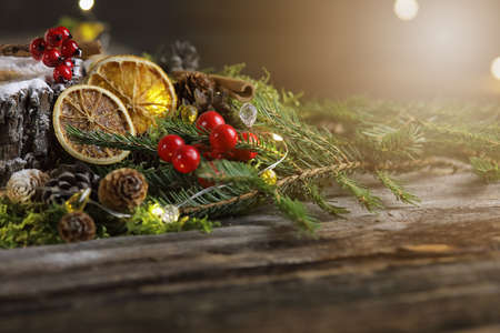 Festive wooden background with fir branches, oranges, cones and berriesの写真素材