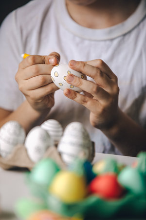 Child paint eggs with different colors.の写真素材