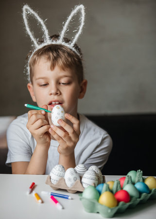 Child paint eggs with different colors.の写真素材