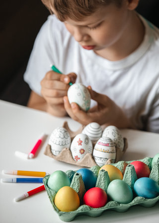 Child paint eggs with different colors.の写真素材