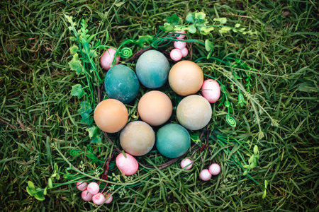 Easter eggs in grass against blurred green background. spring holidays conceptの写真素材