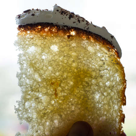 Half-cut homemade sweet easter bread in the hands of a baker's woman. Slice of easter orthodox sweet...