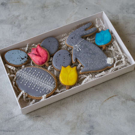 Happy family holiday, presents in box , gingerbread easter cookies in form of rabbits and eggs....
