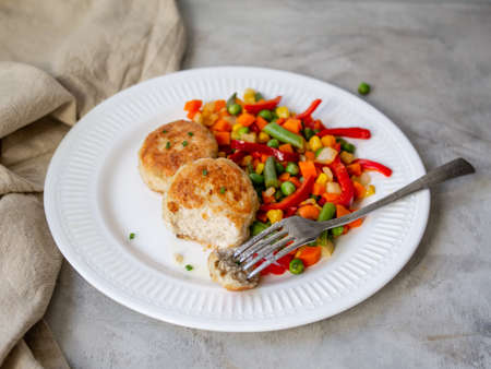 Chicken cutlets with steamed Mix vegetables, Chicken meat balls on white plate. Heathy lunch, diet food. Selective focus, close up.の写真素材