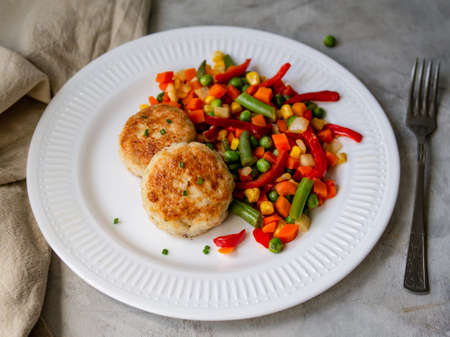 Chicken cutlets with steamed Mix vegetables, Chicken meat balls on white plate. Heathy lunch, diet food. Selective focus, close up.の写真素材