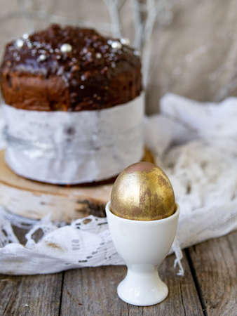 Amazing Chocolate Easter Cake with chocolate drops and dry cherries on an old wooden background with...