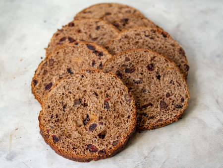 Amazing Chocolate Easter Cake with chocolate drops and dry cherries on gray wooden background. Round slices of cake. Easter concept. Selective focus, close up.の写真素材