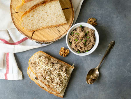 Pate of fish with mackerel, nuts, sour cream with homemade bread on gray background. Healthy breakfast, lunch, snack. Close up, selective focus.の写真素材
