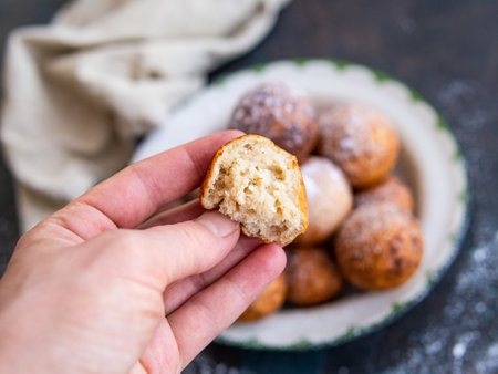 Beautiful breakfast. Cottage cheese donuts balls with sugar powder on a dark background. Close up. Copy spaceの写真素材