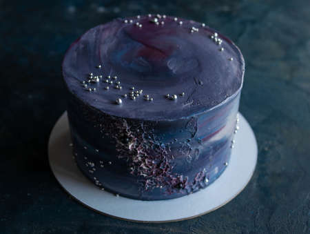 Space-themed cake. Cake decorated with stars on a dark background. NASA cake. Copy space, close up.の写真素材