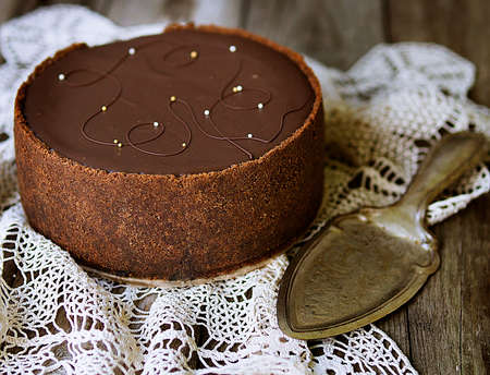 Classic cheesecake with chocolate. Gentle delicious dessert on old wooden table. Close up.の写真素材