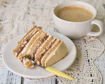 Delicious slice of honey cake on wooden background.の写真素材