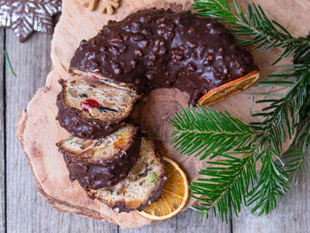 Christmas fruit cake, pudding on wooden plate with ginger cookies and chokolate-nut glaze. Copy space. Close upの写真素材