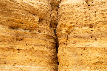 sand orange rock texture, crack in yellow stoneの写真素材