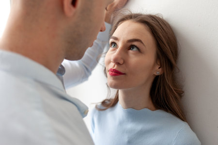 young serious couple in love looking into eyes closely, woman in eye contact with man in relationshipの写真素材