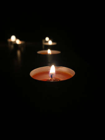 Beautiful burning candles. In a dark room.の写真素材