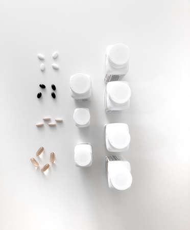 Beautiful cans of vitamins on a white table. Vitamins on the white Table. Tablets on a white table.の写真素材
