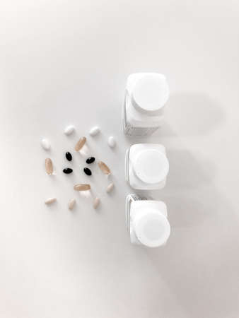 Beautiful cans of vitamins on a white table. Vitamins on the white Table. Tablets on a white table.の写真素材